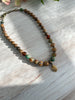 Earthy Necklace Featuring Matte Colourful Druk Beads & a Brass Wheat Grass Charm