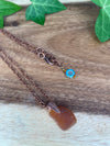 Golden Brown Sea Glass Pendant Necklace With a Flower Charm